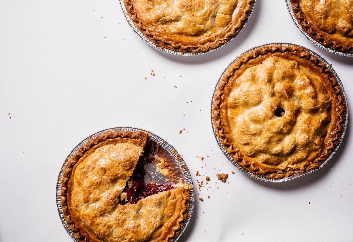 Four cherry pies with slice missing