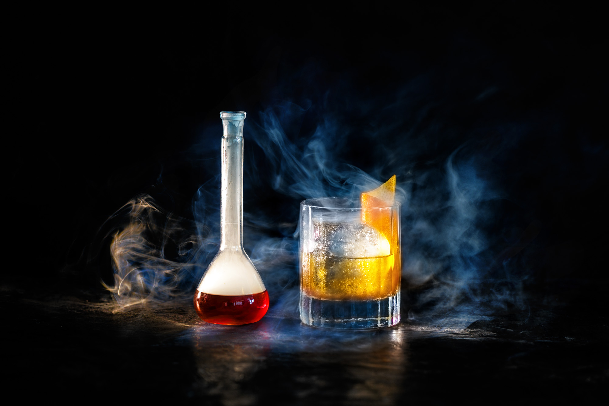 Smoked old fashioned with dry ice pouring out of decanter