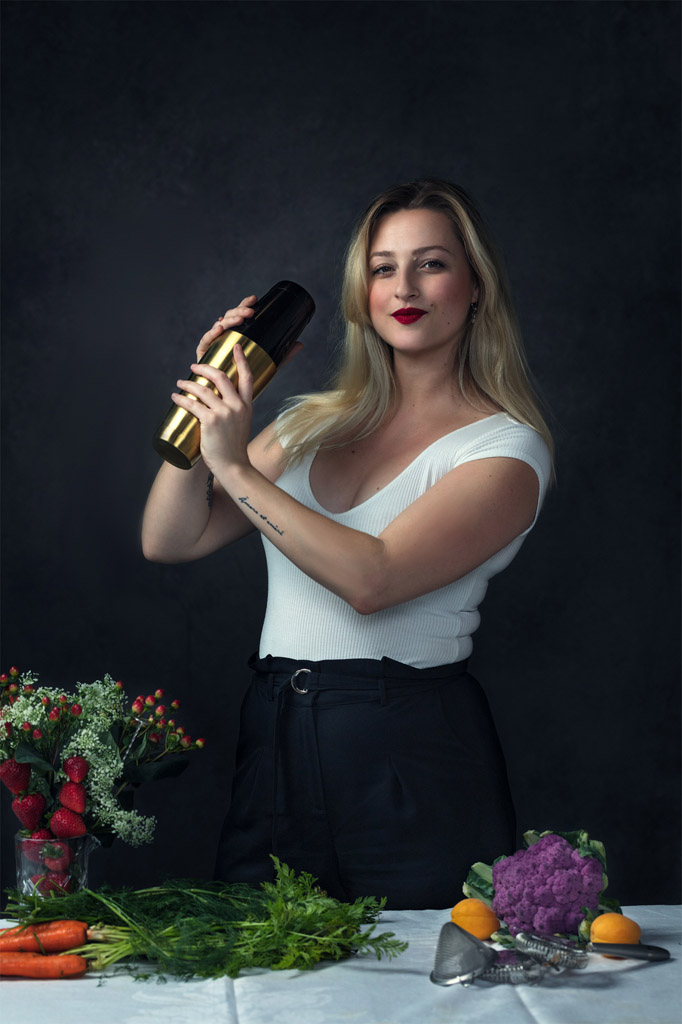 Dreamy photo of beautiful bartender holding a cocktail shaker