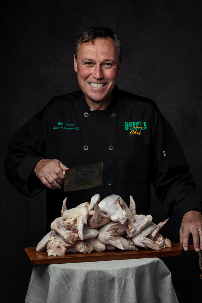 Duffy's Chef holds machete before cutting a dozen chicken wings