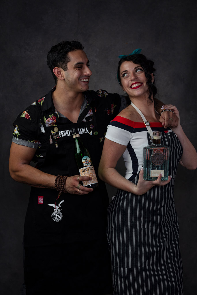 Two mixologists holding Fernet smile at each other