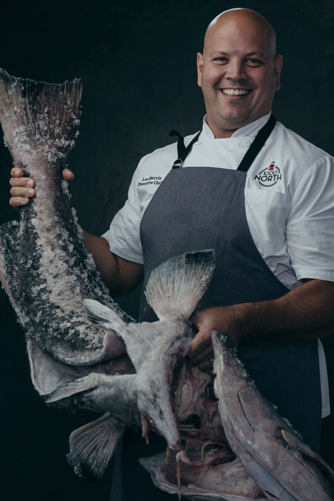 Chef poses with very large raw fish