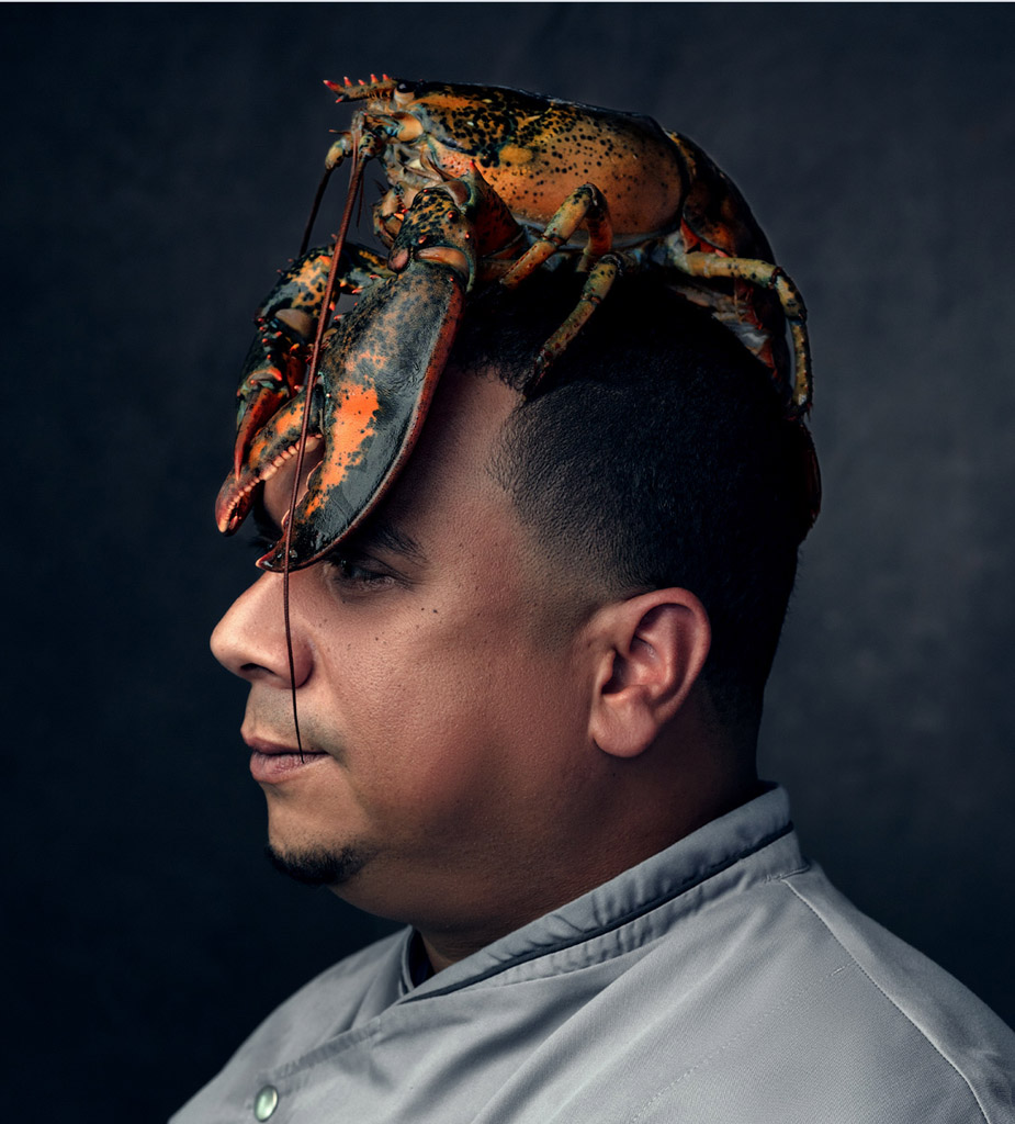 Chef with a huge lobster sitting on his head