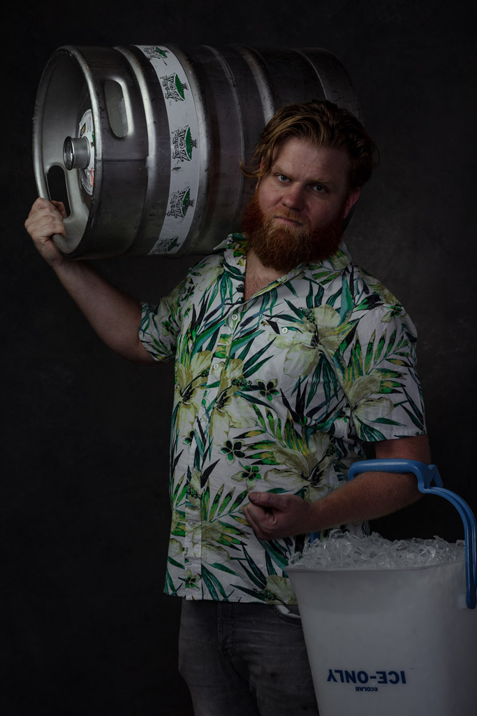 Strong brewer holds keg over his shoulder
