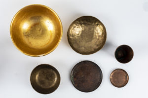 Gold and brass bowls and plates