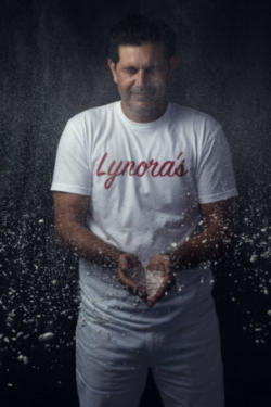 Creative portrait of chef tossing flour into the air
