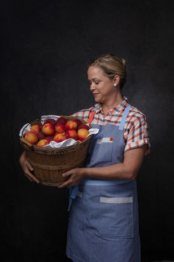 Beautiful chef Lindsay Autry holding a barrel of peaches