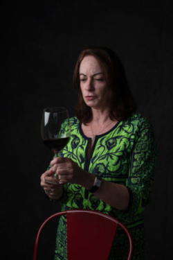 Wine sommelier studies a glass of wine
